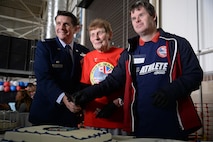 U.S. Air Force Col. Christopher Amrhein, 100th Air Refueling Wing commander, volunteer Iris Weimer, volunteerand Neil Draper, perform the cake cutting ceremony for the 36th Annual Joan Mann Special Sports Day, Sept. 23, 2017, on RAF Mildenhall, England. The event opened with the lighting of the Olympic torch and the “Parade of Athletes,” followed by the sporting events, and concluded with medal presentations. (U.S. Air Force photo by Senior Airman Christine Groening)