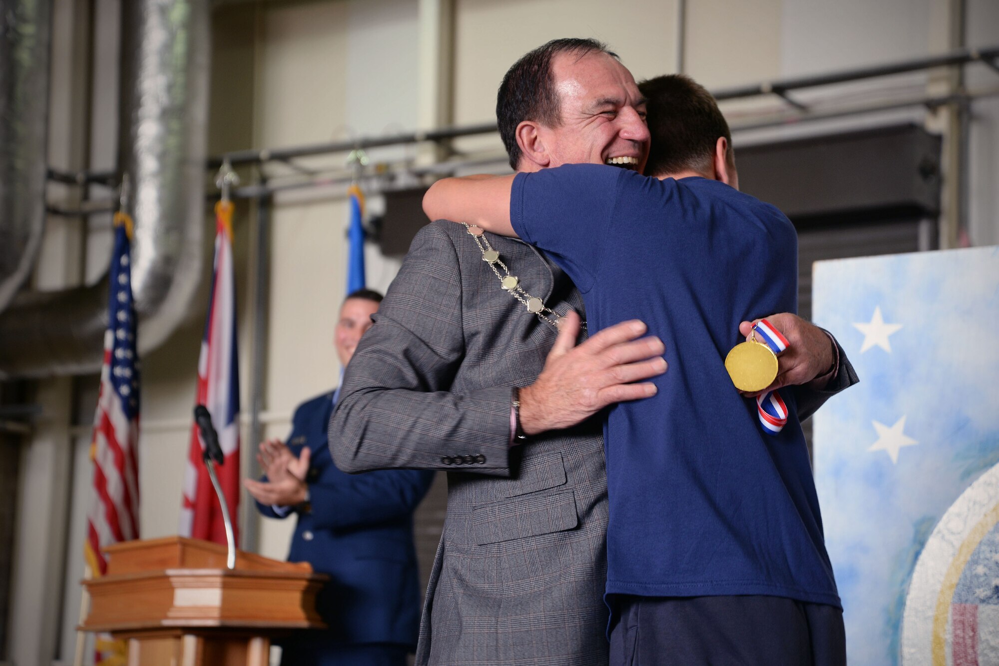 Councilor Terry Clements, Mayor of Edmundsbury, embraces one of the winning athletes during the awards ceremony for Joan Mann Specials Sports Day, Sept. 23, 2017, at RAF Mildenhall, England. The event was established 36 years ago when Joan Mann, a Ministry of Defence employee on RAF Mildenhall, wanted to find a way to bring the local community and military members together to work with special-needs citizens.  (U.S. Air Force photo by Senior Airman Christine Groening)