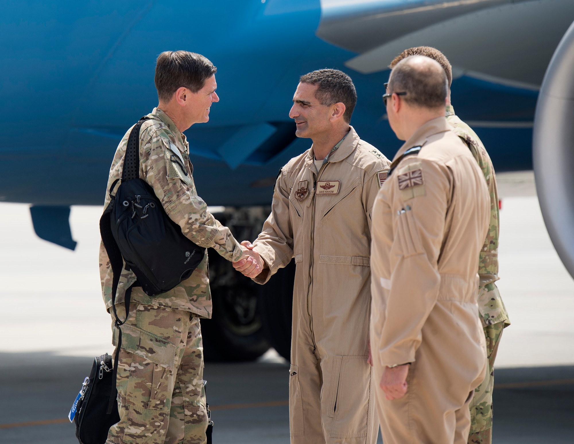 U.S. Air Force Maj. Gen. David Nahom, center, deputy commander, U.S. Air Forces Central Command, greets U.S. Army Gen. Joseph Votel, U.S. Central Command commander, at Al Udeid Air Base, Qatar, Sept. 8, 2017.