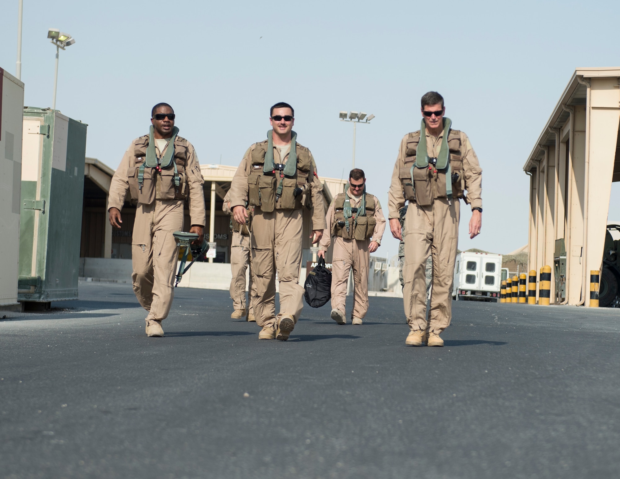 U.S. Army Gen. Joseph Votel, right, U.S. Central Command commander, walks with U.S. Air Force Airmen with the 69th Expeditionary Bomb Squadron at Al Udeid Air Base, Qatar, Sept. 8, 2017.