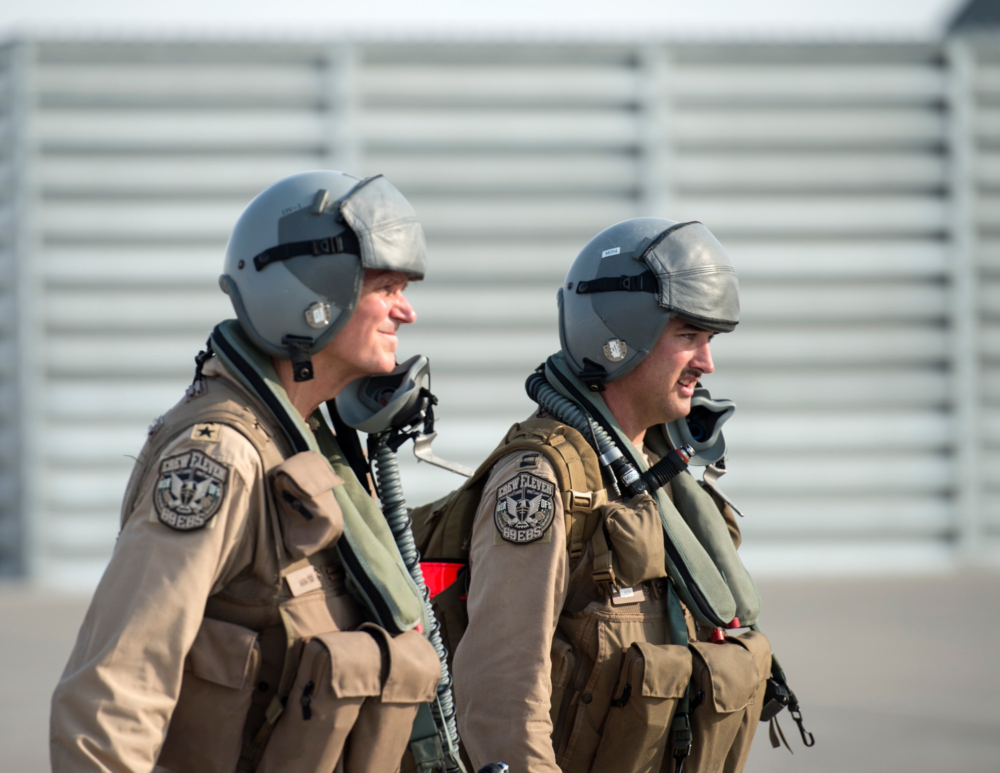 U.S. Air Force Capt. Micah McCracken, right, 69th Expeditionary Bomb Squadron aircraft commander, walks with U.S. Army Gen. Joseph Votel, left, U.S. Central Command commander, to a B-52 Stratofortress at Al Udeid Air Base, Qatar, Sept. 8, 2017.