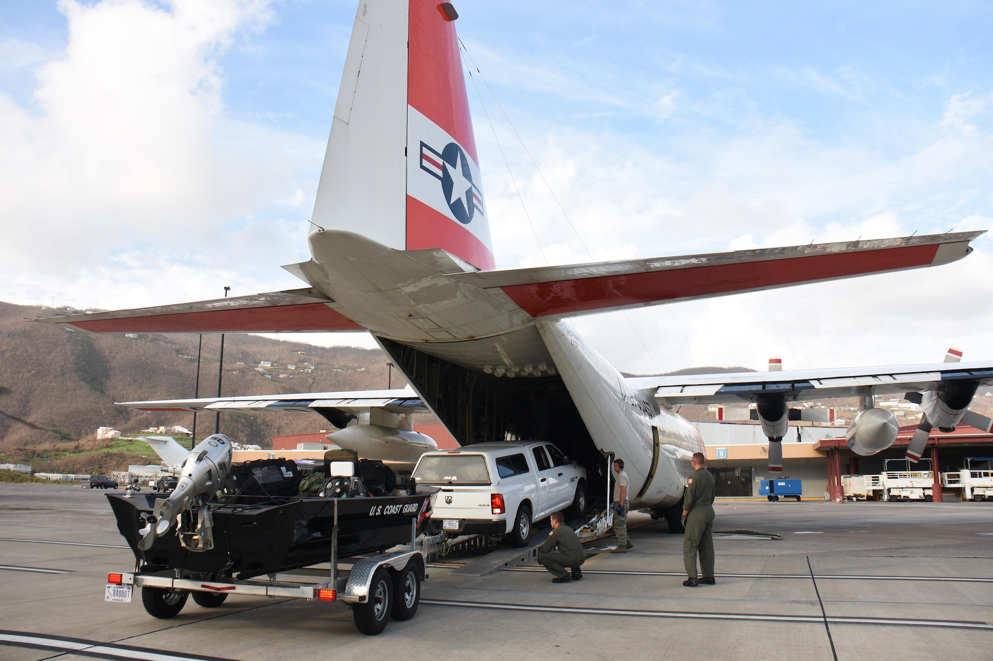Air transportation specialists with the Air National Guard's 133rd Airlift Wing in Minneapolis, Minnesota assist with the download of cargo from a U.S. Coast Guard C-130H Hercules at Cyril E. King Airport in St. Thomas, U.S. Virgin Islands, Sept. 15, 2017. 133rd AW personnel joined Airmen assigned to the 146th Airlift Control Flight in Channel Islands, Florida and the 161st Air Refueling Wing in Phoenix, Arizona to manage air operations at the storm damaged airport in St. Thomas in the wake of Hurricane Irma. (U.S. Air National Guard photo by Master Sgt. Paul Gorman)