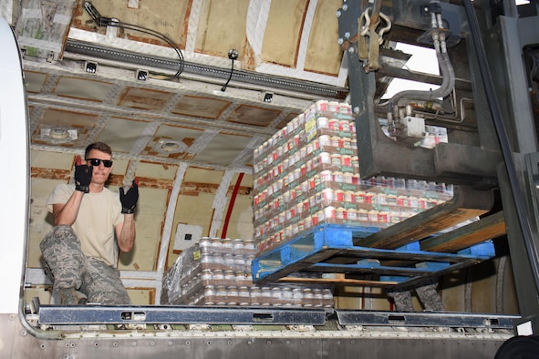 Air National Guard Master Sgt. Matt Hill, air transportation specialist with the 133rd Airlift Wing in Minneapolis, Minnesota, directs the offload of food and supplies pallets at Cyril E. King Airport in St. Thomas, U.S. Virgin Islands, Sept. 15, 2017. 133rd AW personnel joined Airmen assigned to the 146th Airlift Wing in Camarillo, California and the 161st Air Refueling Wing in Phoenix, Arizona to manage air operations at the storm damaged airport in St. Thomas in the wake of Hurricane Irma. (U.S. Air National Guard photo by Master Sgt. Paul Gorman)