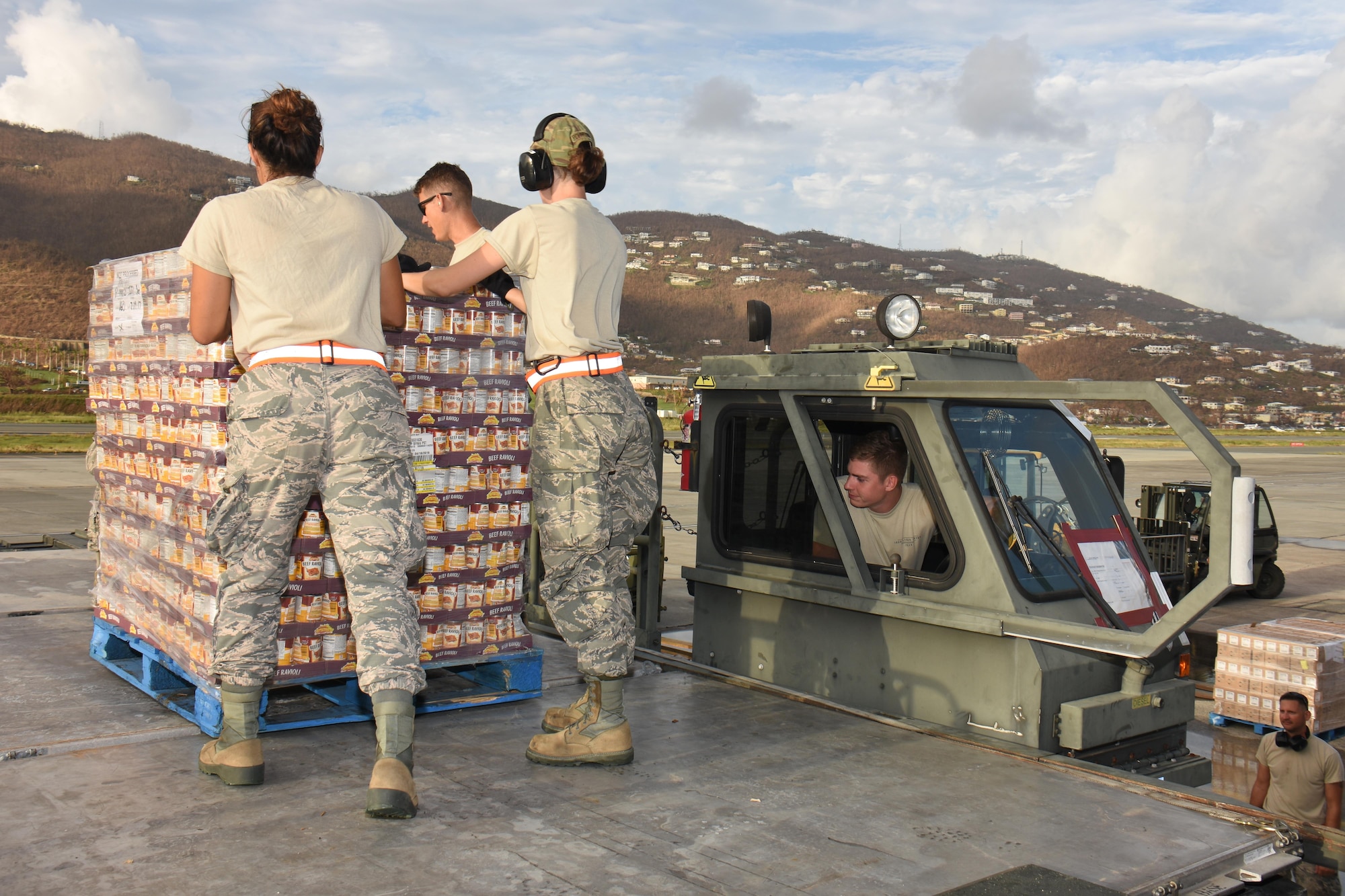 Air transportation specialists with the Air National Guard's 133rd Airlift Wing in Minneapolis, Minnesota utilize a Halvorsen loader to offload pallets of food and supplies at Cyril E. King Airport in St. Thomas, U.S. Virgin Islands, Sept. 15, 2017. 133rd AW personnel joined Airmen assigned to the 161st Air Refueling Wing in Phoenix, Arizona, and 146th Airlift Wing in Camarillo, California to manage air operations at the storm damaged airport in St. Thomas in the wake of Hurricane Irma. (U.S. Air National Guard photo by Master Sgt. Paul Gorman)