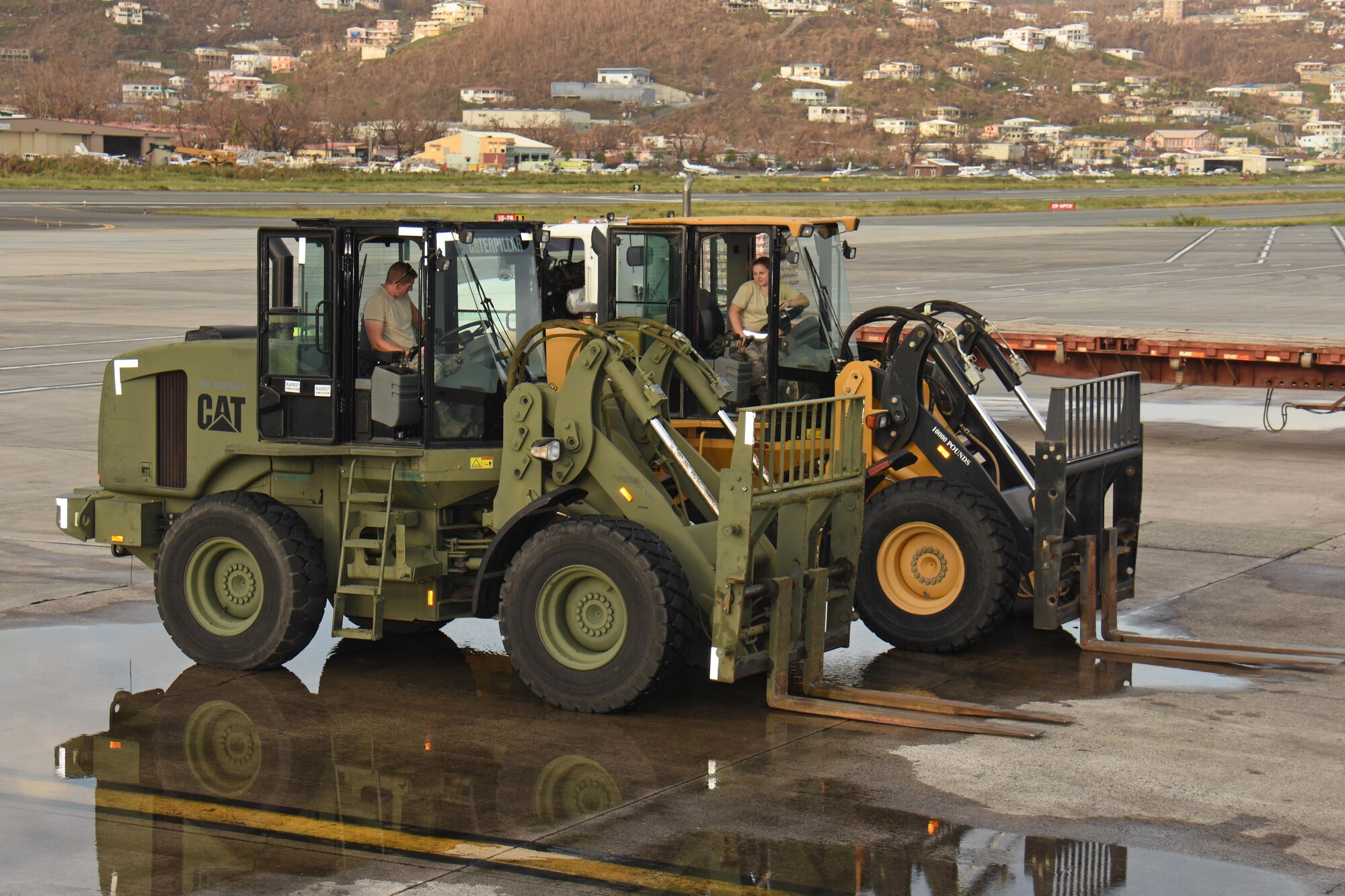 Staff Sgt. Ross Wehrle, left, and Senior Airman McKayla Harrington, air transportation specialists with the Air National Guard's 133rd Airlift Wing in Minneapolis, Minnesota prepare to offload pallets of food and supplies at Cyril E. King Airport in St. Thomas, U.S. Virgin Islands, Sept. 15, 2017. 133rd AW personnel joined Airmen assigned to the 161st Air Refueling Wing in Phoenix, Arizona, and 146th Airlift Wing in Camarillo, California to manage air operations at the storm damaged airport in St. Thomas in the wake of Hurricane Irma. (U.S. Air National Guard photo by Master Sgt. Paul Gorman)