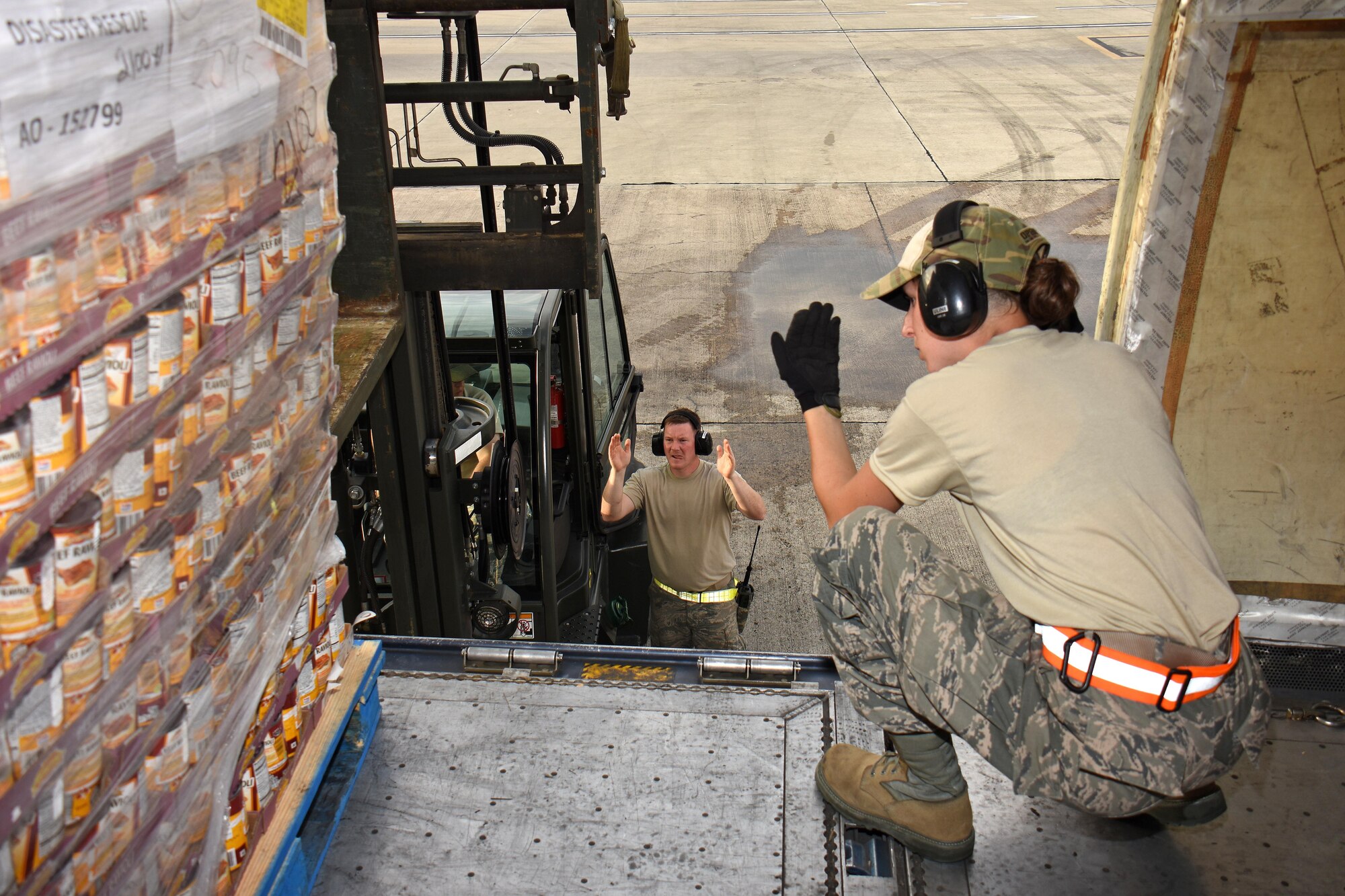 Air transportation specialist Staff Sgt. Heather Boutin with the Air National Guard's 133rd Airlift Wing in Minneapolis, Minnesota, directs the offload of food and supplies pallets at Cyril E. King Airport in St. Thomas, U.S. Virgin Islands, Sept. 15, 2017. 133rd AW personnel joined Airmen assigned to the 161st Air Refueling Wing in Phoenix, Arizona, and 146th Airlift Wing in Camarillo, California to manage air operations at the storm damaged airport in St. Thomas in the wake of Hurricane Irma. (U.S. Air National Guard photo by Master Sgt. Paul Gorman)