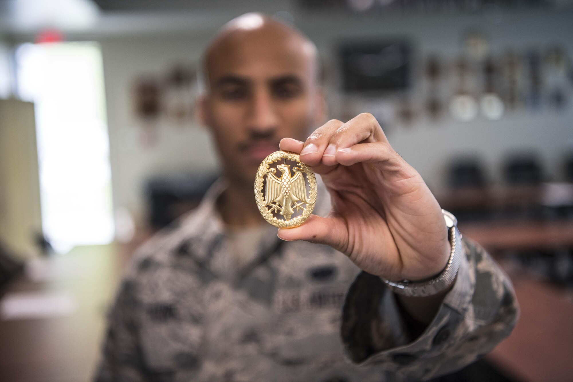 Staff Sgt. Johnathan Flynn, a defender with the 130th Airlift Wing, holds the gold German Armed Forces Proficiency Badge (GAFPB), Sept. 16, 2017, at McLaughlin Air National Guard Base, Charleston, West Virginia. The GAFPB a decoration of the Bundeswehr, the Armed Forces of the Federal Republic of Germany. As one of the few foreign badges that are authorized to be worn on the U.S. military uniform, the GAFPB is one of the most highly sought-after awards. Flynn earned the gold badge after completing a rigorous course with nine other defenders from the 130th AW. (U.S. Air National Guard photo by Tech. Sgt. De-Juan Haley)