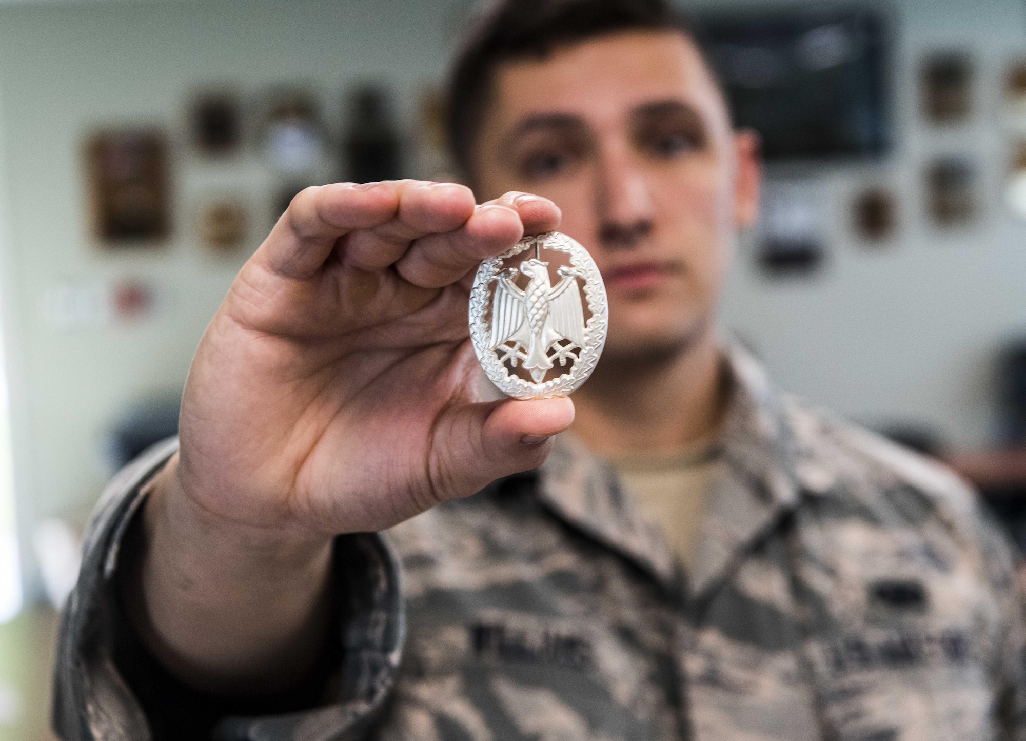Staff Sgt. Brody Williams, 130th Airlift Wing defender, holds the gold German Armed Forces Proficiency Badge (GAFPB) he earned Sept. 16, 2017, at McLaughlin Air National Guard Base, Charleston, West Virginia. The GAFPB a decoration of the Bundeswehr, the Armed Forces of the Federal Republic of Germany. As one of the few foreign badges that are authorized to be worn on the U.S. military uniform, the GAFPB is one of the most highly sought-after awards. Williams earned the gold badge after completing a rigorous course with nine other defenders from the 130th AW.(U.S. Air National Guard photo by Tech. Sgt. De-Juan Haley)
