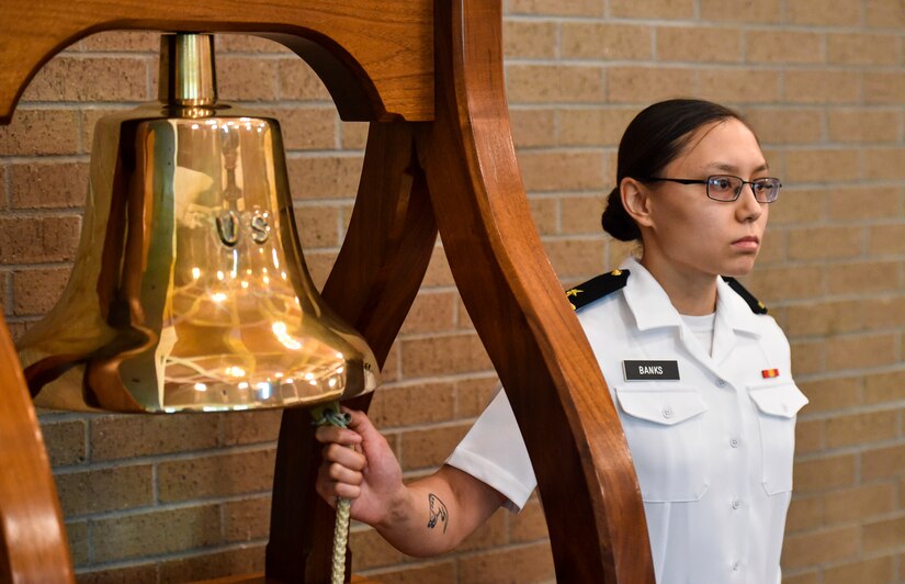 Ens. Jannel Banks, Navy Nuclear Power Training Command student, rings the bell commemorating fallen service members at Joint base Charleston-Weapons Station, S.C., Sept. 21, 2017.