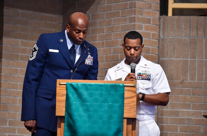 Senior Master Sgt. Derrick Sherrod, left, 437th Maintenance Squadron first sergeant, and Culinary Specialist Senior Chief Corey Montgomery, right, read the names of fallen service members at Joint Base Charleston-Weapons Station, S.C., Sept. 21, 2017.