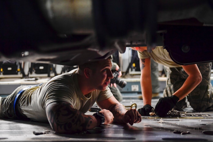 A member of the 437th Aerial Port Squadron secures a truck to a C-17 Globemaster III at Joint Base Charleston, S.C., Sept. 23, 2017. The 14th Airlift Squadron, 437th Airlift Wing, flew a mobile air traffic control tower, food and water to St. Thomas, Virgin Islands in support of Hurricane Maria relief efforts.