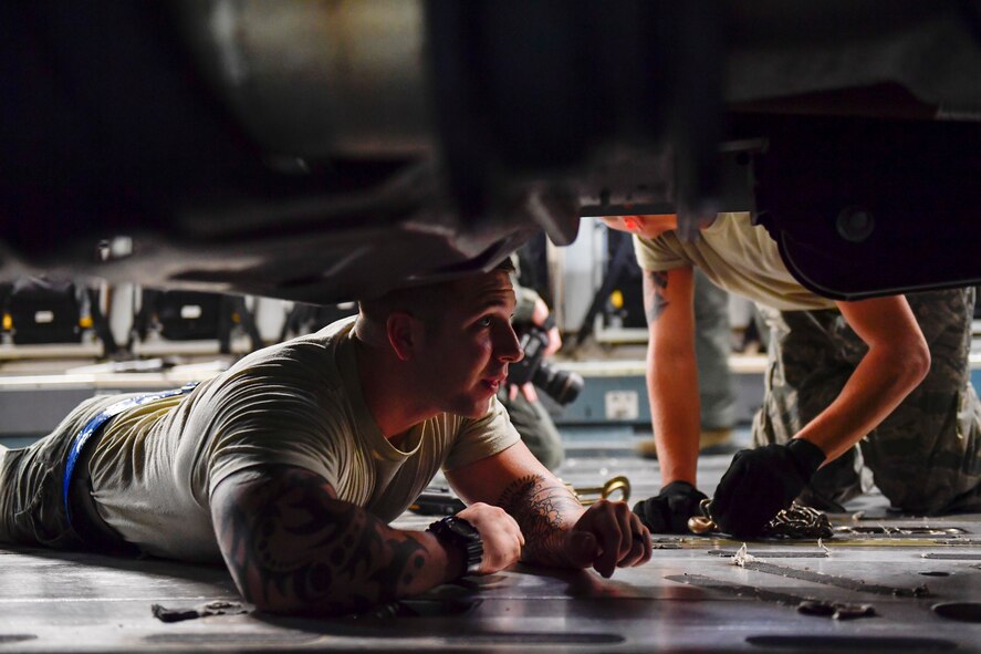 A member of the 437th Aerial Port Squadron secures a truck to a C-17 Globemaster III at Joint Base Charleston, S.C., Sept. 23, 2017. The 14th Airlift Squadron, 437th Airlift Wing, flew a mobile air traffic control tower, food and water to St. Thomas, Virgin Islands in support of Hurricane Maria relief efforts.