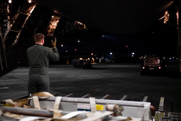 Senior Airman Mark Darnell, 14th Airlift Squadron loadmaster, directs the movement of cargo at Joint Base Charleston, S.C., Sept 23, 2017. The 14th AS, 437th Airlift Wing, flew a mobile air traffic control tower, food and water to St. Thomas, Virgin Islands in support of Hurricane Maria relief efforts.