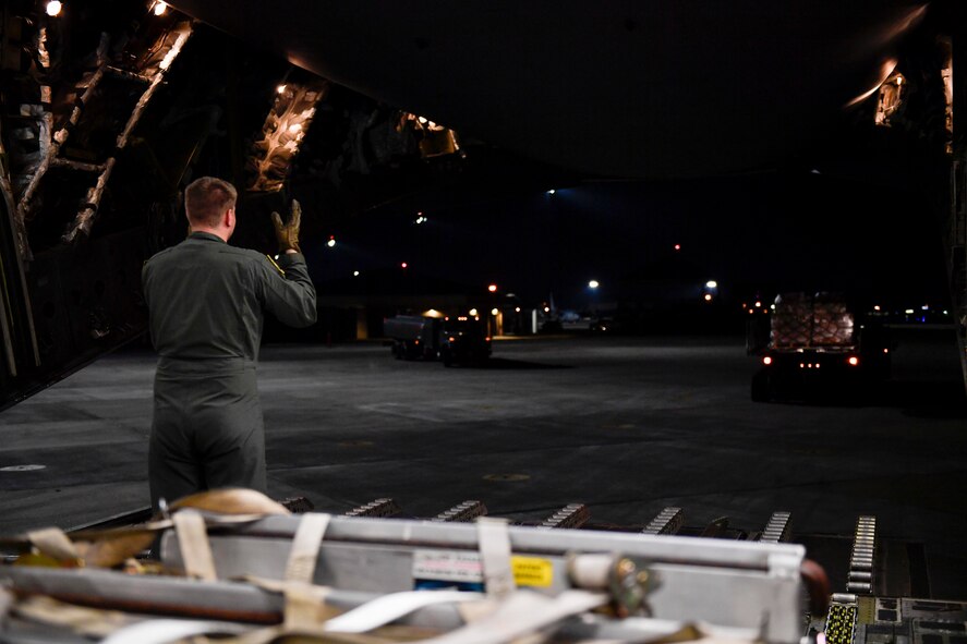 Senior Airman Mark Darnell, 14th Airlift Squadron loadmaster, directs the movement of cargo at Joint Base Charleston, S.C., Sept 23, 2017. The 14th AS, 437th Airlift Wing, flew a mobile air traffic control tower, food and water to St. Thomas, Virgin Islands in support of Hurricane Maria relief efforts.