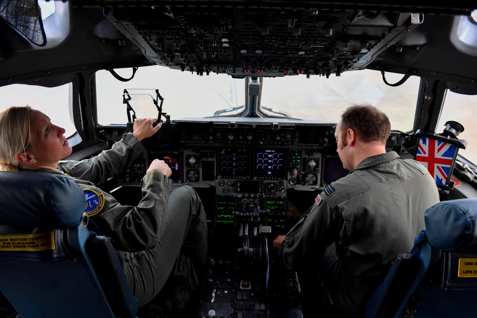 Maj. Kari Flemming, left, 14th Airlift Squadron pilot, and Flight Lt. Matt Jenkinson, right, 14th AS Royal air force exchange pilot, both from Joint Base Charleston, S.C., perform preflight checks at Kelly Field in San Antonio, Texas, Sept. 24, 2017. Members of the 14th AS delivered more than 129,000 pounds of food and water to St. Croix, Virgin Islands in support of relief efforts after Hurricane Maria. The mission to St. Croix marked the second mission the crew flew to the Virgin Islands for humanitarian aid in 48 hours.