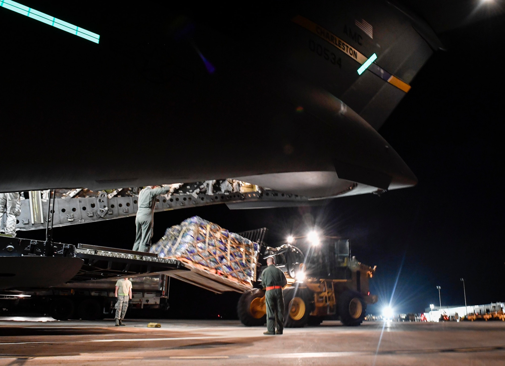 Airmen unload a pallet of water from a Joint Base Charleston C-17 Globemaster III in St. Croix, Virgin Islands, Sept. 24, 2017. Members of the 14th Airlift Squadron, 437th Airlift Wing, delivered more than 129,000 pounds of food and water to St. Croix in support of relief efforts after Hurricane Maria. The mission to St. Croix marked the second mission the crew flew to the Virgin Islands for humanitarian aid in 48 hours.