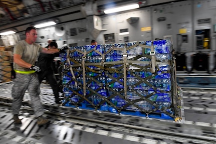 Airmen unload a pallet of water from a Joint Base Charleston C-17 Globemaster III in St. Croix, Virgin Islands, Sept. 24, 2017. Members of the 14th Airlift Squadron, 437th Airlift Wing, delivered more than 129,000 pounds of food and water to St. Croix in support of relief efforts after Hurricane Maria. The mission to St. Croix marked the second mission the crew flew to the Virgin Islands for humanitarian aid in 48 hours.