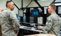 Staff Sgt. Eric Rzepa, 436th Communications Squadron Comm Focal Point NCO in charge, right, briefs Col. Randy Boswell, 436th Mission Support Group commander, left, on the process of upgrading computers on the consolidated work bench Sept. 7, 2017, on Dover Air Force Base, Del. Personnel upgrading computers have the capability to rollout up to 250 assets per week with Windows 10 to permanent party and some tenant units at Dover. (U.S. Air Force photo by Roland Balik)