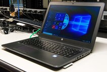 A laptop computer running Windows 10 Secure Host Baseline version 5.3 sits on the 436th Communications Squadron consolidated work bench waiting to be checked by client service technicians Sept. 21, 2017, on Dover Air Force Base, Del. The upgrade from Windows 7 to Windows 10 and the use of a single operating system across the Department of Defense will help improve cybersecurity and help reduce information technology costs. (U.S. Air Force photo by Roland Balik)