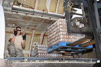 Air National Guard Master Sgt. Matt Hill, air transportation specialist with the 133rd Airlift Wing in Minneapolis, Minnesota, directs the offload of food and supplies pallets at Cyril E. King Airport in St. Thomas, U.S. Virgin Islands, Sept. 15, 2017. 133rd AW personnel joined Airmen assigned to the 146th Airlift Wing in Camarillo, California and the 161st Air Refueling Wing in Phoenix, Arizona to manage air operations at the storm damaged airport in St. Thomas in the wake of Hurricane Irma. (U.S. Air National Guard photo by Master Sgt. Paul Gorman)