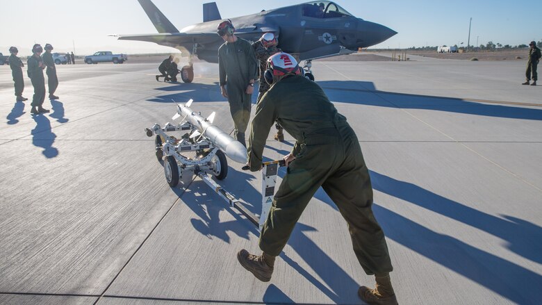 U.S. Marines with Marine Fighter Attack Squadron 121 Load Ordnance on a F-35B Lightning II