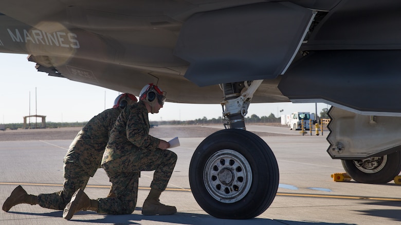 U.S. Marines with Marine Fighter Attack Squadron 121 Load Ordnance on a F-35B Lightning II