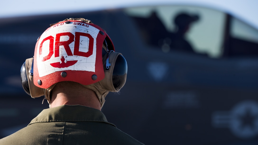 U.S. Marines with Marine Fighter Attack Squadron 121 Load Ordnance on a F-35B Lightning II