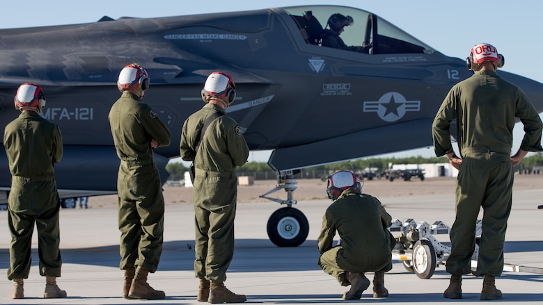 U.S. Marines with Marine Fighter Attack Squadron 121 Load Ordnance on a F-35B Lightning II