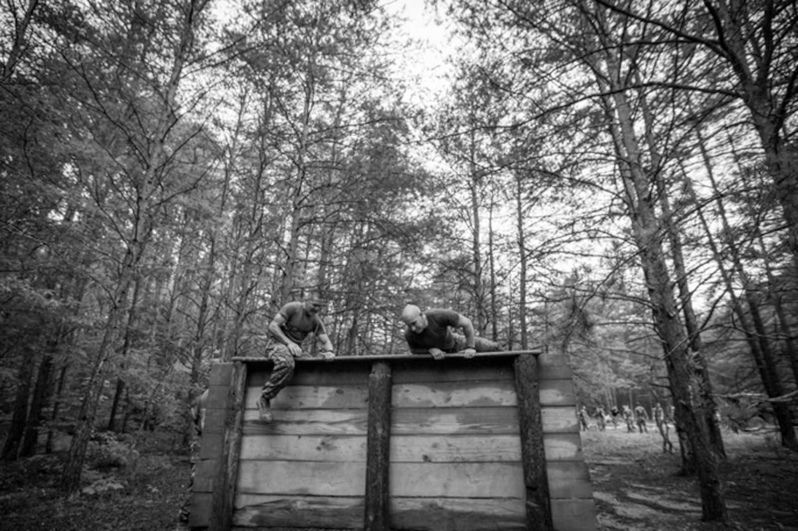 Two Marines scale a wall as part of an Endurance Course / Obstacle Course Physical Training Session during Force Fitness Instructor Course 4-17.