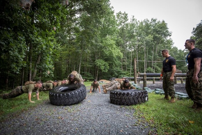 Marines conduct tire flips as part of a physical fitness competition with oversight from Force Fitness Instructor Trainers Sgt Cody Anderson and SSgt Britt Churchill during Force Fitness Instructor Course 4-17.