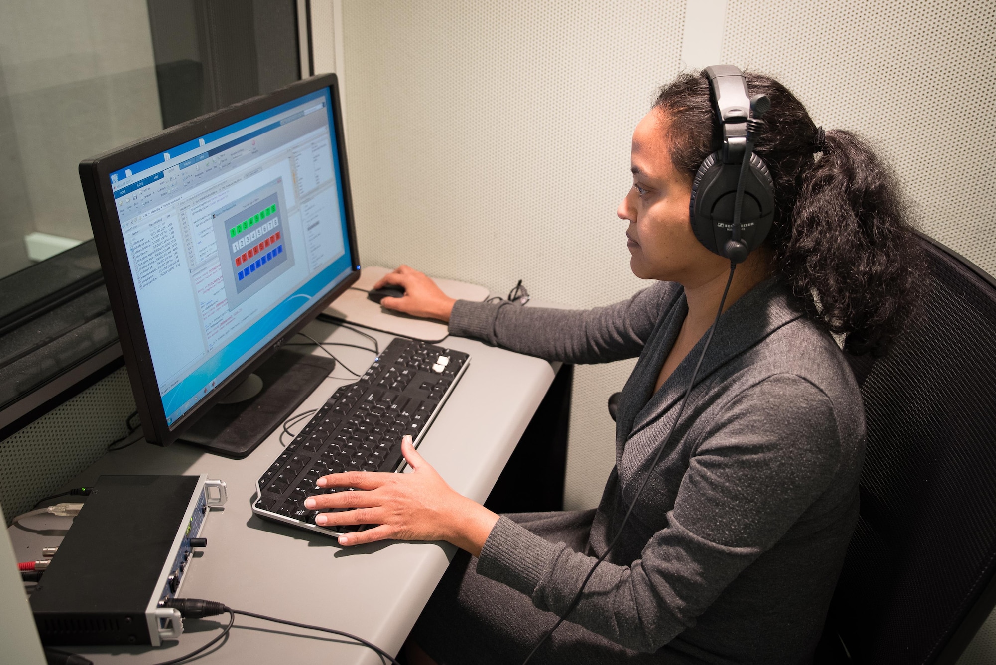 Nandini Iyer, a research audiologist in the 711th Human Performance Wing, studies data in one of her laboratories.