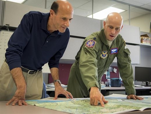 Lt. Col. Robert Clark, AFOTEC Detachment 2 Air Armament Division chief, and Paul LaPorta, unit test director, compare legacy navigation charts from the 1960s with newly updated digitized versions. The detachment recently evaluated new, fully digitized navigation charts that will streamline mission planning initiatives for the military as early as 2019. (U.S. Air Force Photo/Jasmine Porterfield)