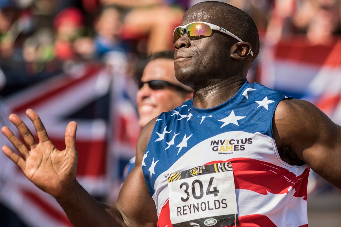 A soldier in an Invictus Games uniform runs in a race.