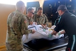 Army medics and civilian flight medics from MedCenter Air transport a patient during a medical evacuation on St. Thomas, U.S. Virgin Islands.