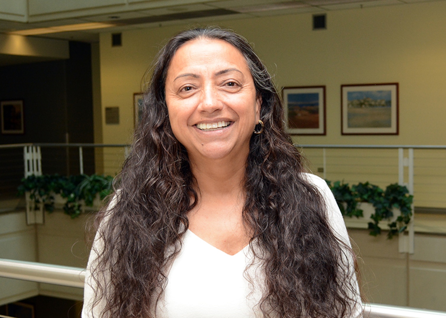 Maria Caro-Stumpf poses for a photo that will be placed along her restaurant