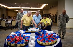 U.S. Air Force retirees Tech. Sgt. Leonard Flesher, left, and Tech. Sgt. Samuel Fried, perform the ceremonial cake cutting with Airman 1st Class Lorelie Budionganon, 628th Force Support Squadron personnel specialist, to celebrate the Air Force’s 70th Anniversary at the Charleston Club,  Sept. 22, 2017.