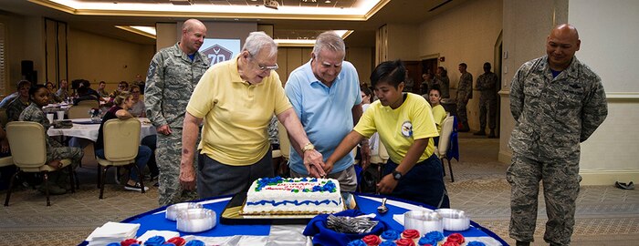 U.S. Air Force retirees Tech. Sgt. Leonard Flesher, left, and Tech. Sgt. Samuel Fried, perform the ceremonial cake cutting with Airman 1st Class Lorelie Budionganon, 628th Force Support Squadron personnel specialist, to celebrate the Air Force’s 70th Anniversary at the Charleston Club,  Sept. 22, 2017.