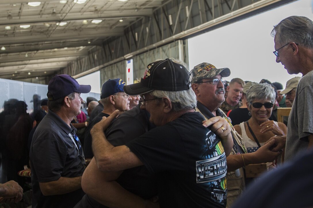 A Mobile Vietnam Memorial Wall volunteer embraces a Vietnam veteran during a pinning ceremony at the 2017 Marine Corps Air Station Miramar Air Show on MCAS Miramar, Calif., Sept. 22. “The 2017 MCAS Miramar Air Show gives the public and current service members an opportunity to say thank you to the veterans of the Vietnam War,” said Col. Jason Woodworth, commanding officer of MCAS Miramar. “Our goal is to remind the veterans that the country cares about them and truly values the sacrifice they made for the American people, regardless of how they were treated when they initially returned from Vietnam.” (U.S. Marine Corps photo by Sgt. Lillian Stephens/Released)