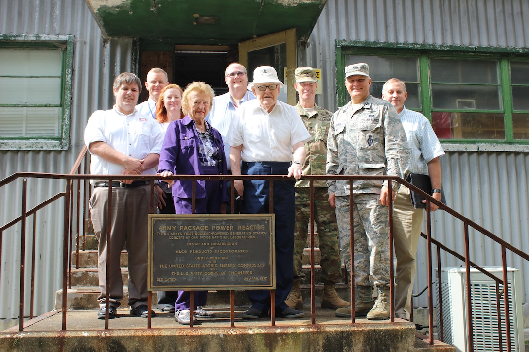 Retired Lt. Gen. Ernest Graves and his wife, Nancy Graves, stand behind the plaque from the April 29, 1957 dedication of SM-1 nuclear reactor and power plant.  During their visit on Tuesday September 19, 2017 with Department of Defense officials, Mrs. Graves recalled the last time she stood at this plaque with her husband more than sixty years prior.  Tour attendees included,  from left to right Chris Gardner, U.S. Army Corps of Engineers, Baltimore District; John Lonnquest, USACE, Headquarters Office of History; Brenda Barber, USACE, Baltimore District; Brian Hearty, USACE, Headquarters, Deactivated Nuclear Power Plant Program; Col. Allan Webster, USACE, Headquarters Military and International Operations; Col. Mark Bowen, Defense Threat Reduction Agency, Defense Nuclear Weapons School; and Matt Thompson, DTRA, Defense Nuclear Weapons School.