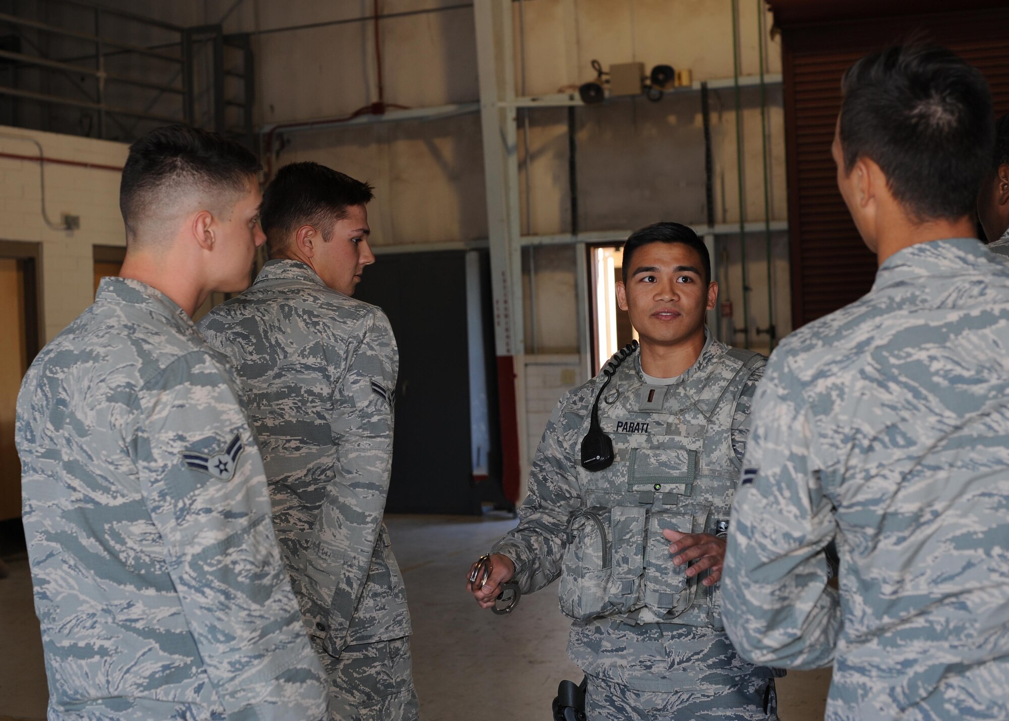 U.S. Air Force 2nd Lt. Robert Parati, 355th Security Forces Squadron flight commander, discusses the importance of technique when handcuffing at Davis-Monthan Air Force Base, Ariz., June 12, 2017. If the offender isn’t properly detained, it can endanger the safety of the arresting officer. (U.S. Air Force photo by Senior Airman Ashley N. Steffen)