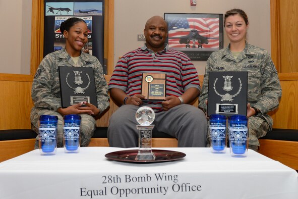 (From left to right) Tech. Sgt. Janay Stokes, Donald Bell, and Staff Sgt. Ashlei Philson, Equal Opportunity advisors assigned to the 28th Bomb Wing, hold four of the offices Col. L. Joseph Brown awards at Ellsworth Air Force Base, S.D., Sept. 22, 2017.  The team was presented their most recent award Sept. 14, and is the fourth consecutive, and fifth overall, Air Force or major command level award they have received. (U.S. Air Force photo by Airman Nicolas Z. Erwin)