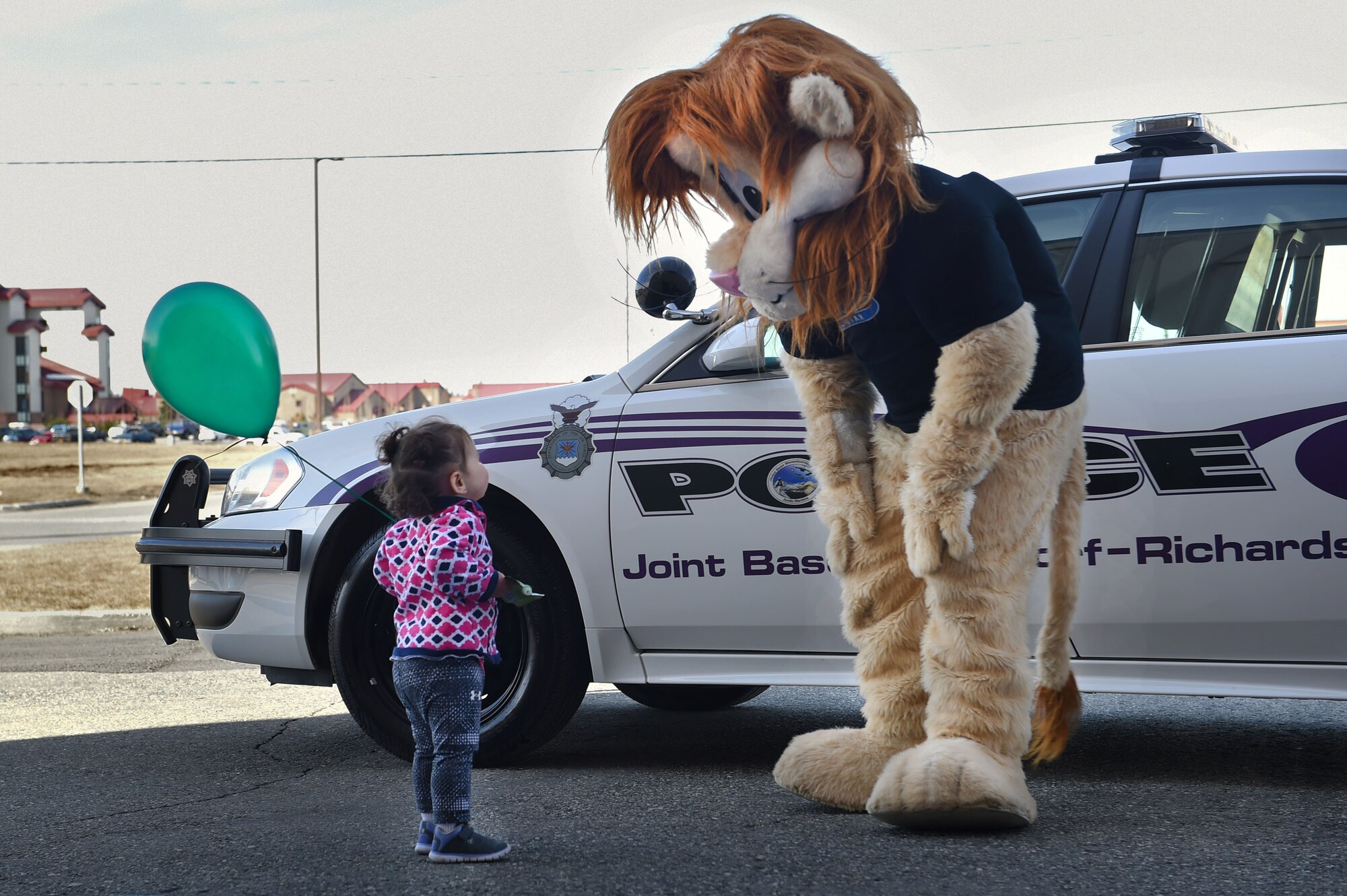 Zoey Pella, 1, greets a mascot during a Kid’s Wellness Fair at the Buckner Physical Fitness Center at Joint Base Elmendorf-Richardson, Alaska, April 22, 2017. The event was hosted to celebrate the Month of the Military Child and offered several projects and activities geared towards overall wellness for children and families.