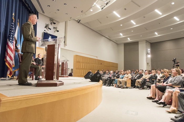 Marine Corps Gen. Joe Dunford speaks from a lectern to a seated audience.
