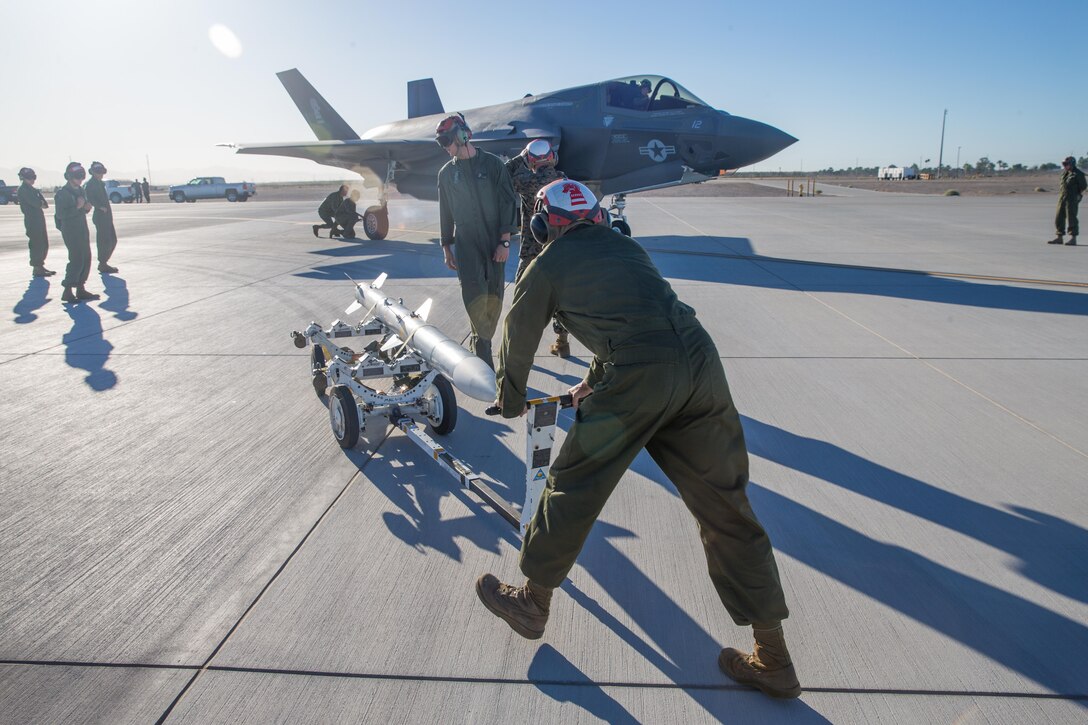 U.S. Marines with Marine Fighter Attack Squadron 121 load ordnance on a F-35B Lightning II while conducting a hotload during Weapons and Tactics Instructor Course (WTI) 1-18 in Yuma, AZ, on Sept. 21, 2017. WTI is a seven week training event hosted by Marine Aviation Weapons and Tactics Squadron (MAWTS-1) cadre which emphasizes operational integration of the six functions of Marine Corps Aviation in support of a Marine Air Ground Task Force. MAWTS-1 provides standardized advanced tactical training and certification of unit instructor qualifications to support Marine Aviation Training and Readiness and assists in developing and employing aviation weapons and tactics.