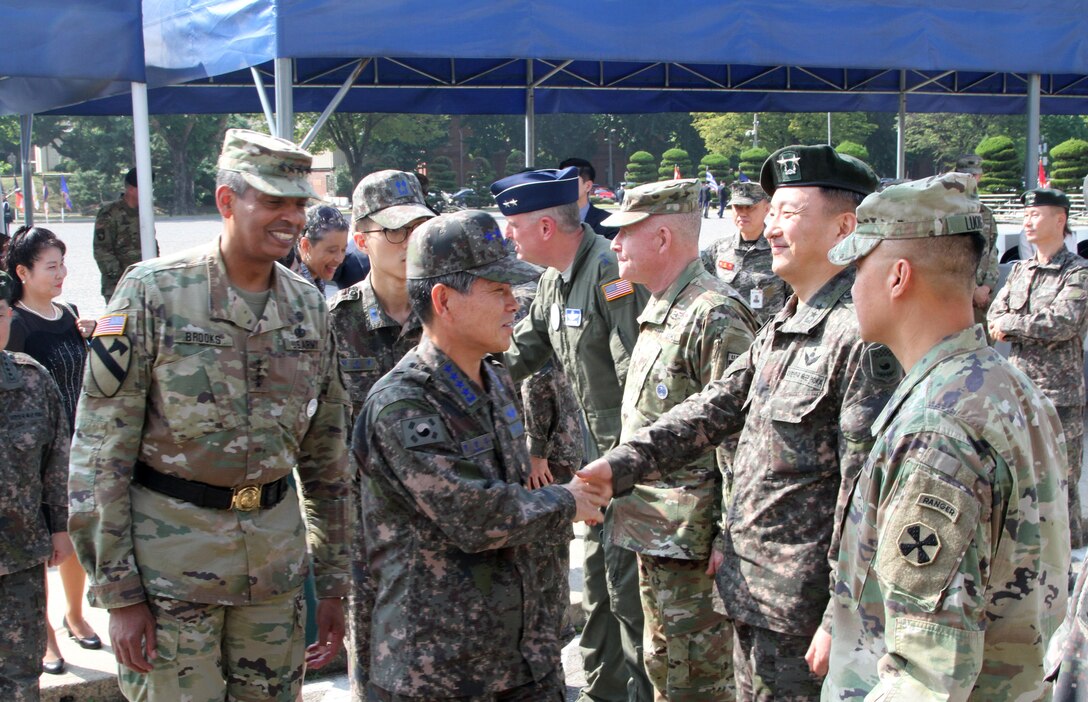 USAG YONGSAN, South Korea -- Republic of Korea Chairman of the Joint Chiefs of Staff Gen. Jeong, Kyeong Doo and Gen. Vincent K. Brooks, Combined Forces Command, United States Forces Command and United Nations Command greet senior leaders after a ceremony welcoming the new ROK CJCS at United States Army Garrison Yongsan, Sept. 26. (U.S. Army photo by Staff Sgt. Steven Schneider)