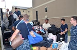 Air Force,  Navy and civilian volunteers from the Medical Education and Training Campus (METC), 59th Training Group, and Navy Medicine Training Support Center (NMTSC) load donations collected for victims of Hurricane Harvey onto a truck for transportation to the sorting area Sept. 19. In all, the team collected and donated 450 pounds of food to the San Antonio Food Bank, $3,300 in donated diapers to the Diaper Bank, $19,000 in clothing and incidentals to the Salvation Army, and numerous donations to the American Society for the Prevention of Cruelty to Animals and homeless shelters.