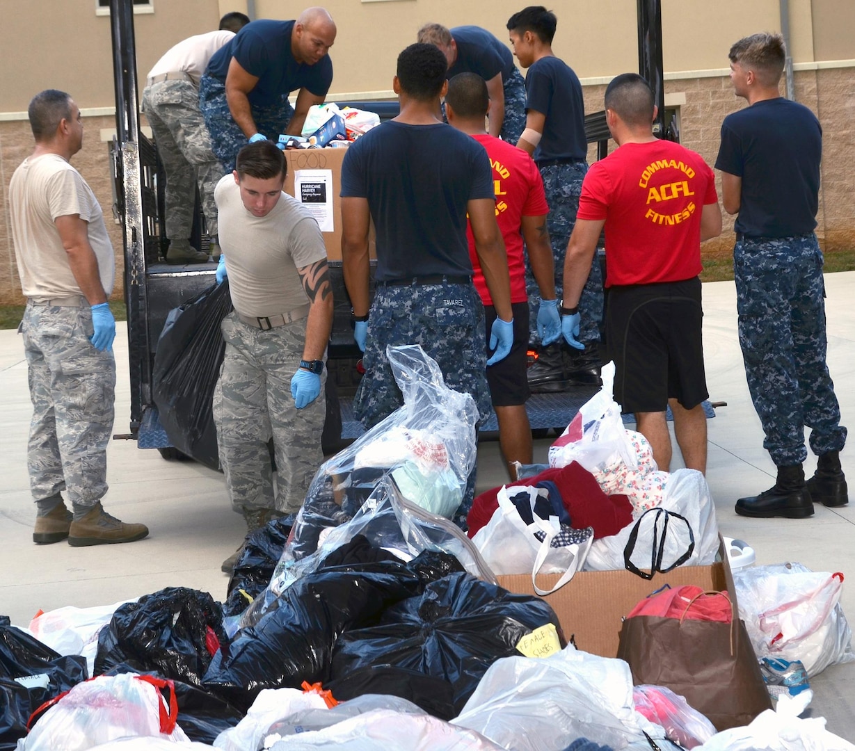 Air Force,  Navy and civilian volunteers from the Medical Education and Training Campus (METC), 59th Training Group, and Navy Medicine Training Support Center (NMTSC) unload donations collected for victims of Hurricane Harvey to the sorting area September 19. In all, the team collected and donated 450 pounds of food to the San Antonio Food Bank, $3,300 in donated diapers to the Diaper Bank, $19,000 in clothing and incidentals to the Salvation Army, and numerous donations to the American Society for the Prevention of Cruelty to Animals and homeless shelters.