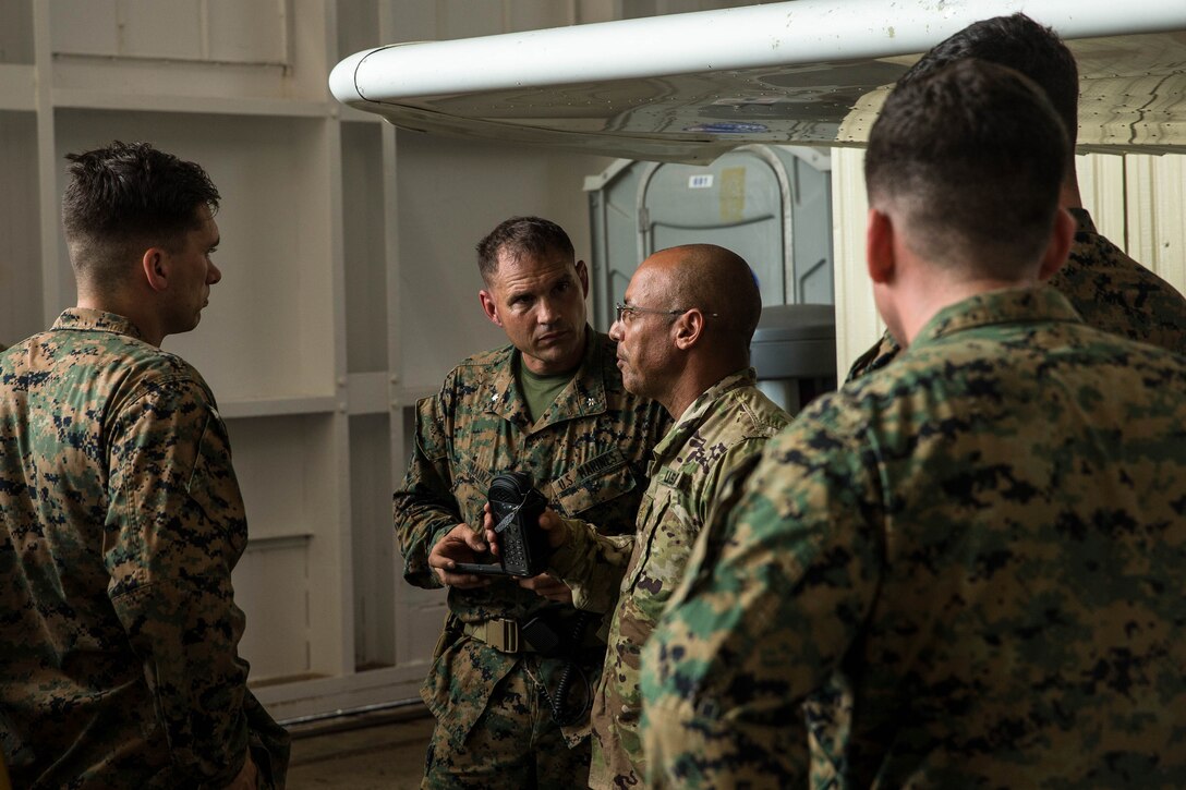 U.S. Marines with Battalion Landing Team 2nd Battalion, 6th Marine Regiment, 26th Marine Expeditionary Unit (MEU), speak with a member of the U.S. Army National Guard about hurricane relief efforts for victims of Hurricane Maria at Jose Aponte de la Torre Airport, Ceiba, Puerto Rico, Sept. 23, 2017. The 26th MEU is supporting the Federal Emergency Management Agency, the lead federal agency, and local authorities in Puerto Rico and the U.S. Virgin Islands with the combined goal of protecting the lives and safety of those in affected areas. (U.S. Marine Corps photo by Lance Cpl. Tojyea G. Matally)