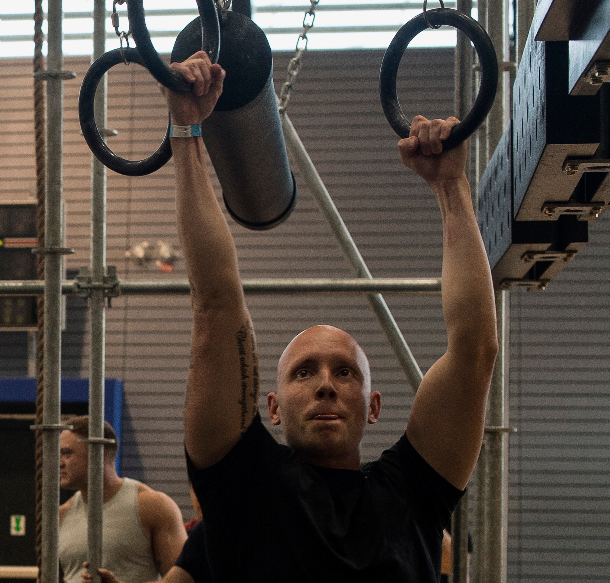 A U.S. Airman hangs from rings while attempting the battering ram portion of the Alpha Warrior’s Battle Rig obstacle course during the Alpha Warrior Tour on Ramstein Air Base, Germany, Sept. 22, 2017. The obstacle course consisted of five lanes that required strength, agility, and stamina to successfully complete. (U.S. Air Force photo by Senior Airman Tryphena Mayhugh)