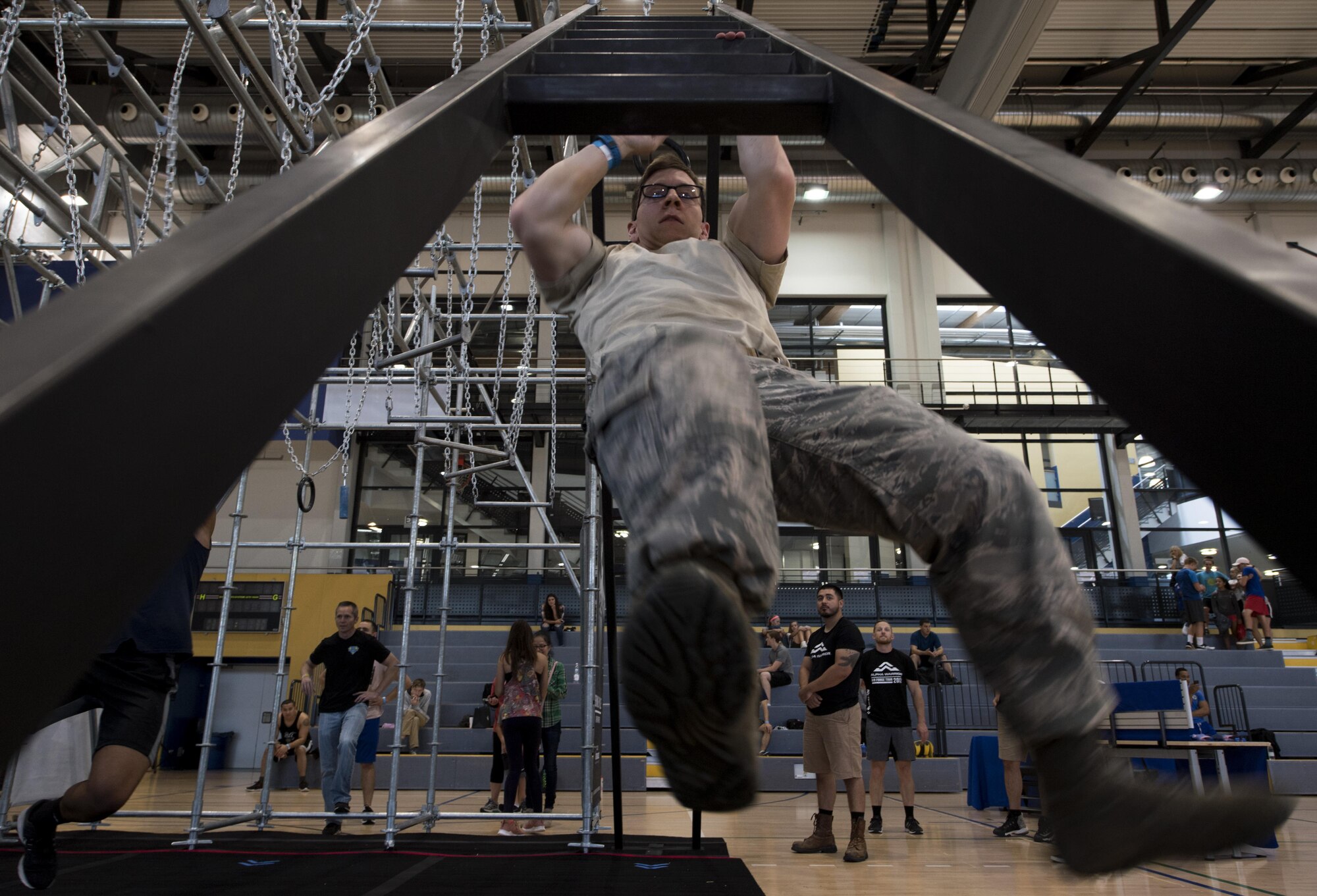 U.S. Air Force Staff Sgt. Cory Aita, 86th Communications Squadron program manager, climbs down the ladder portion of the Alpha Warrior’s Battle Rig obstacle course during the Alpha Warrior Meet/Greet and Familiarization Tour on Ramstein Air Base, Germany, Sept. 22, 2017. Aita was the top male competitor for the Alpha Warrior regional competition held on Sept. 23, 2017, with a run time of one minute and five seconds. (U.S. Air Force photo by Senior Airman Tryphena Mayhugh)